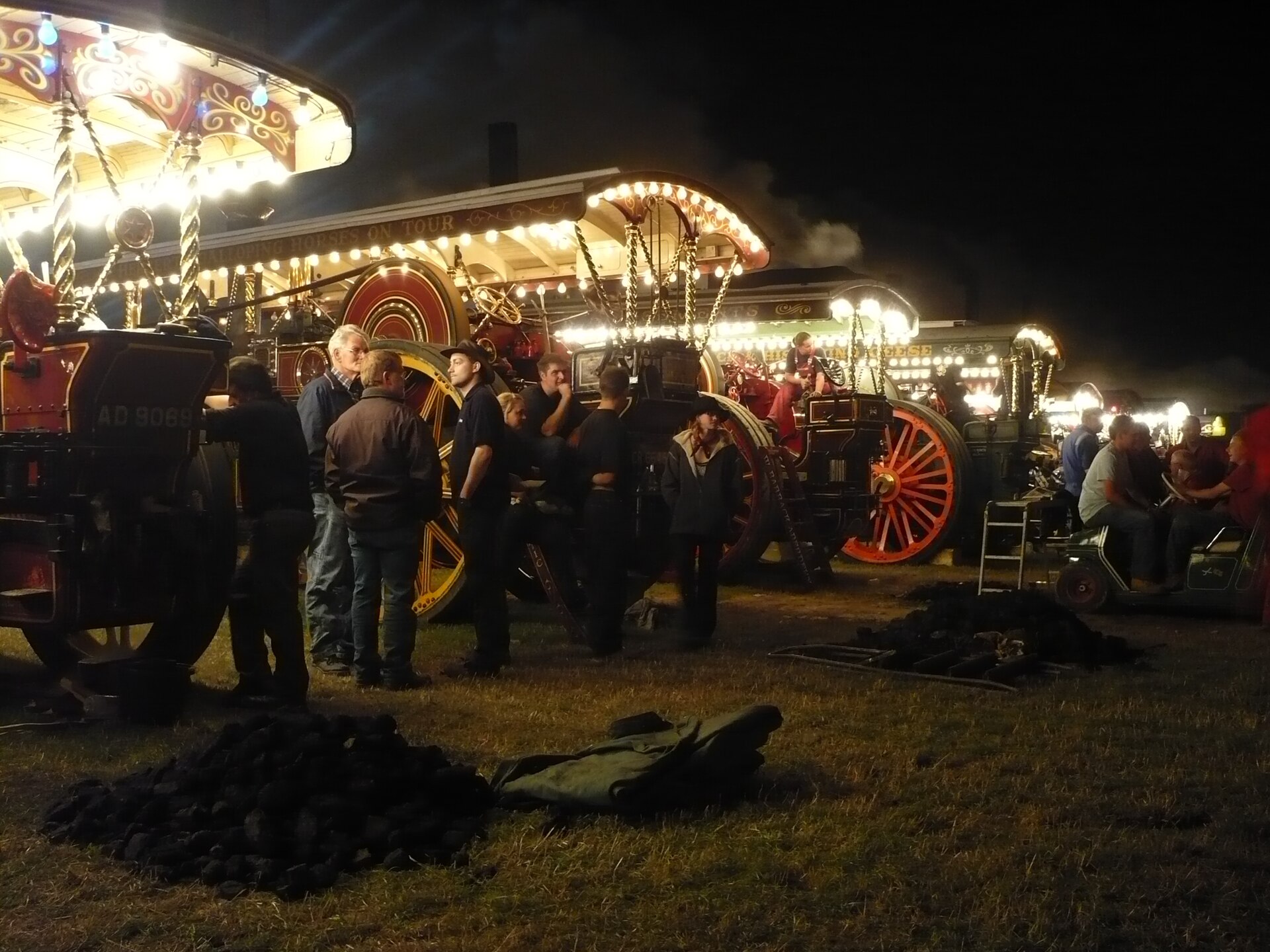 Two showman's engines lit up with electric bulbs at night at the Great Dorset Steam Fair, Tarrant Hinton, in August 2008.